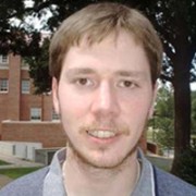 Man with light brown hair and scruffy facial hair